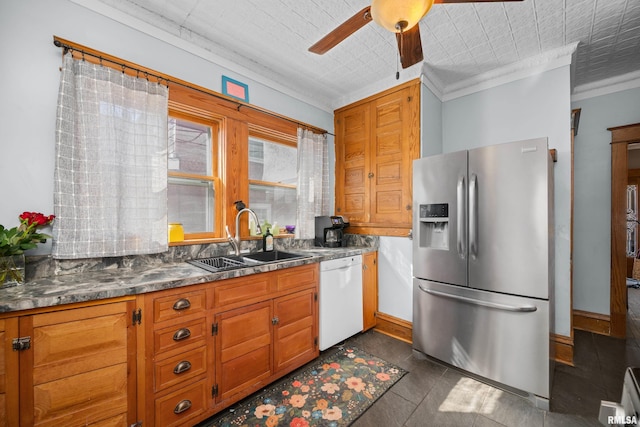 kitchen with a ceiling fan, a sink, white dishwasher, brown cabinetry, and stainless steel fridge with ice dispenser