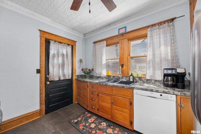 kitchen with baseboards, brown cabinets, white dishwasher, an ornate ceiling, and a sink