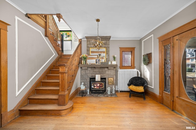 interior space with crown molding, stairs, radiator heating unit, and wood finished floors