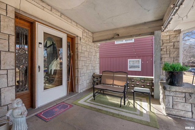 doorway to property featuring stone siding