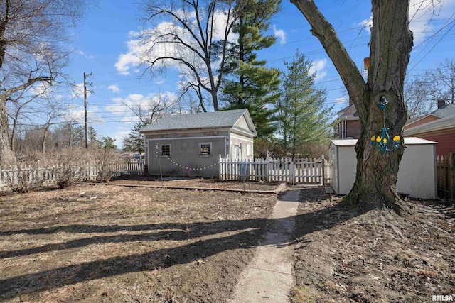 view of yard featuring an outbuilding and fence private yard