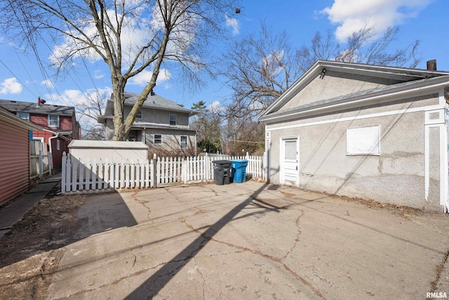 exterior space featuring a patio area, stucco siding, and fence