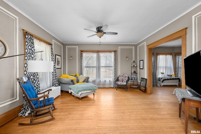 sitting room featuring ornamental molding, ceiling fan, and wood finished floors