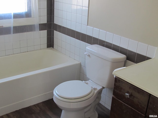 full bath with a washtub, toilet, tile walls, and wood finished floors