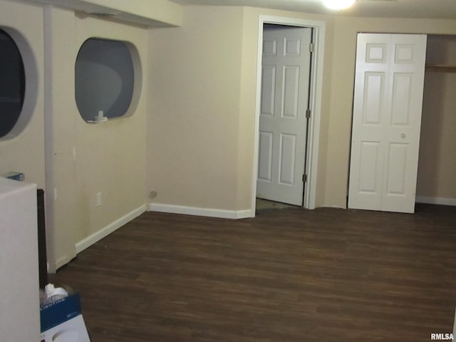 interior space featuring wood finished floors and baseboards