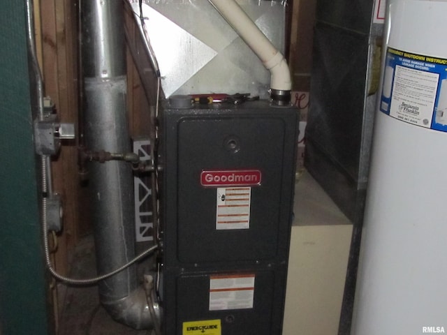 utility room featuring gas water heater and heating unit