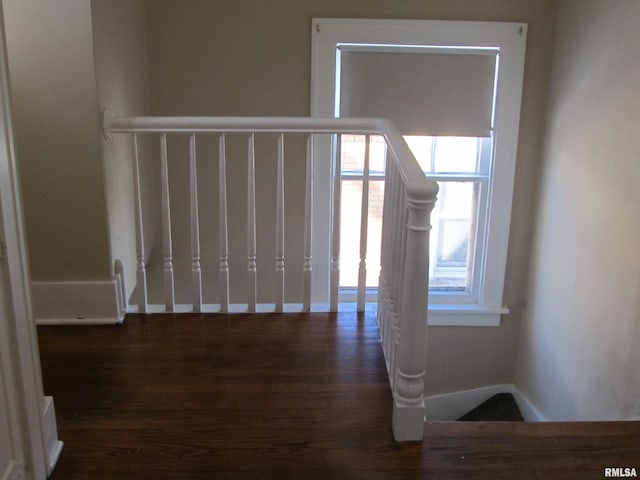 interior space with baseboards and dark wood-style flooring