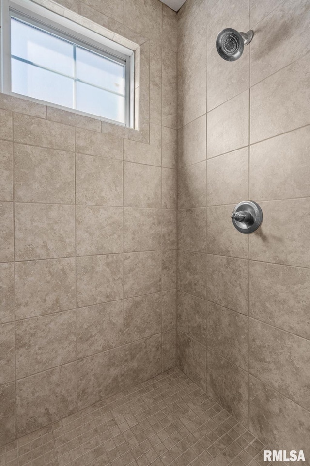 full bath featuring a tile shower