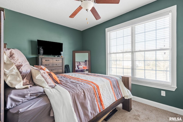 bedroom with ceiling fan, baseboards, and carpet floors