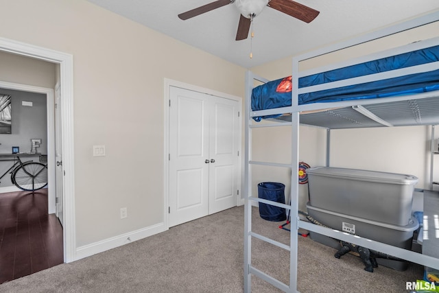 bedroom with a closet, baseboards, carpet floors, and ceiling fan