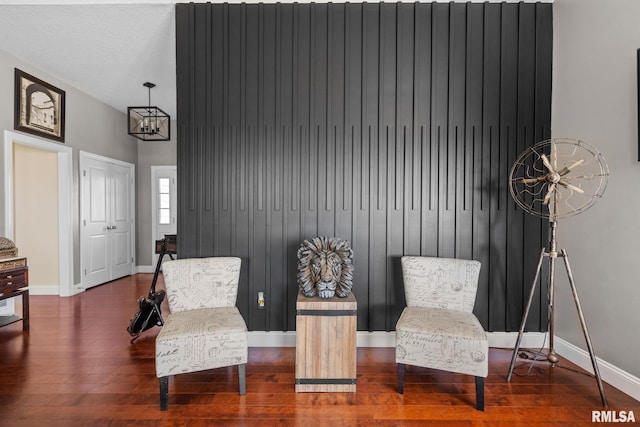 living area with baseboards and wood finished floors