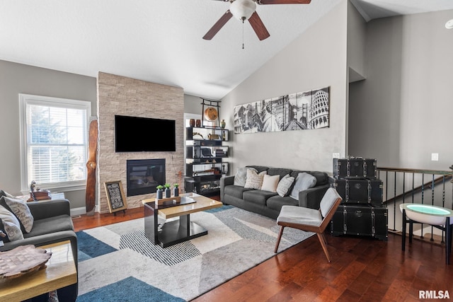 living area featuring a fireplace, high vaulted ceiling, wood finished floors, and a ceiling fan