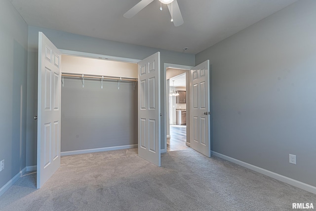 unfurnished bedroom featuring a closet, carpet flooring, a ceiling fan, and baseboards