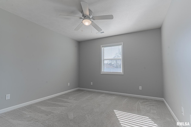 spare room with visible vents, baseboards, ceiling fan, and carpet flooring