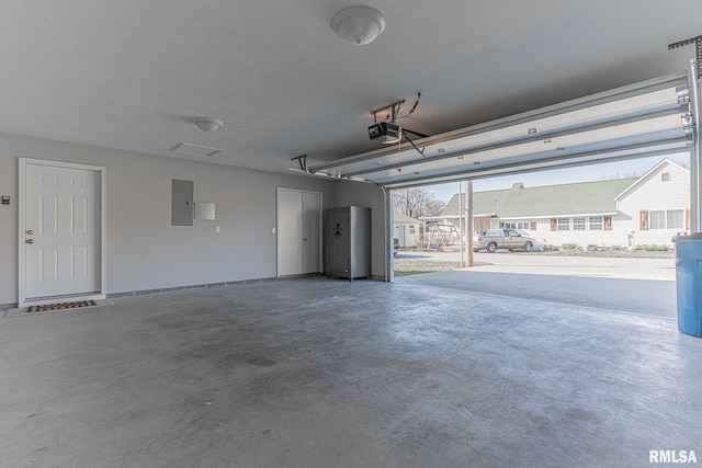 garage featuring electric panel and a garage door opener