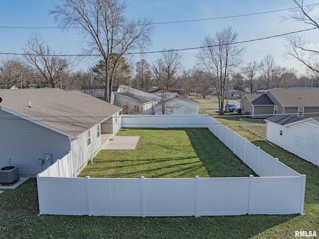 view of yard featuring central AC and a fenced backyard