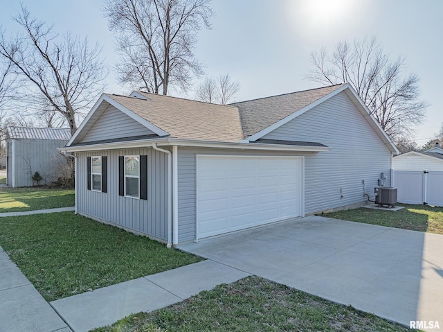 view of side of property featuring a lawn, central AC, roof with shingles, concrete driveway, and a garage