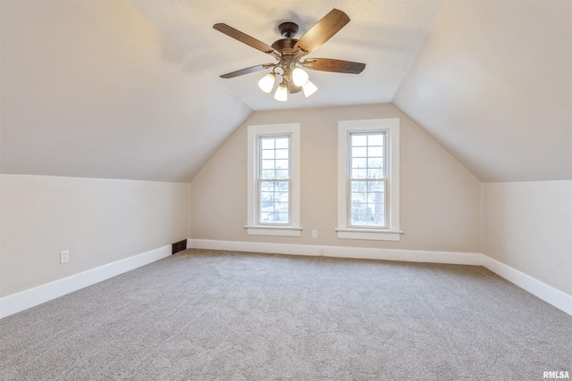 bonus room featuring baseboards, carpet, a ceiling fan, and vaulted ceiling