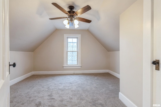 additional living space featuring vaulted ceiling, a ceiling fan, baseboards, and carpet floors