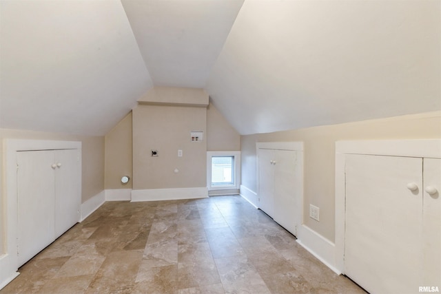 bonus room with baseboards and vaulted ceiling