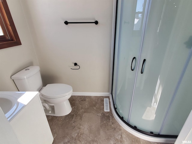 bathroom with visible vents, toilet, a stall shower, baseboards, and vanity