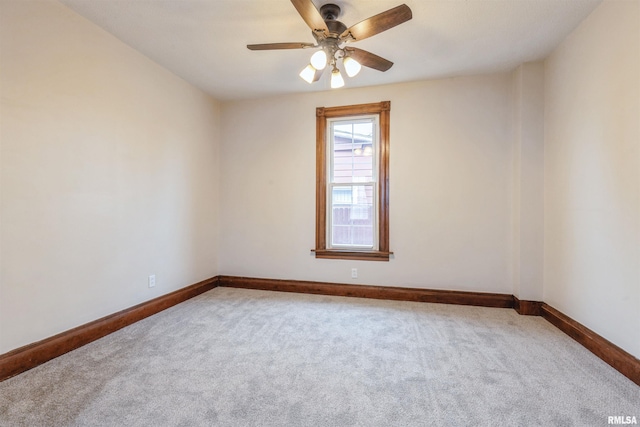 unfurnished room featuring carpet, baseboards, and ceiling fan