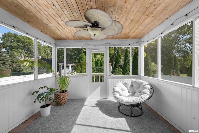 sunroom / solarium featuring wooden ceiling and ceiling fan