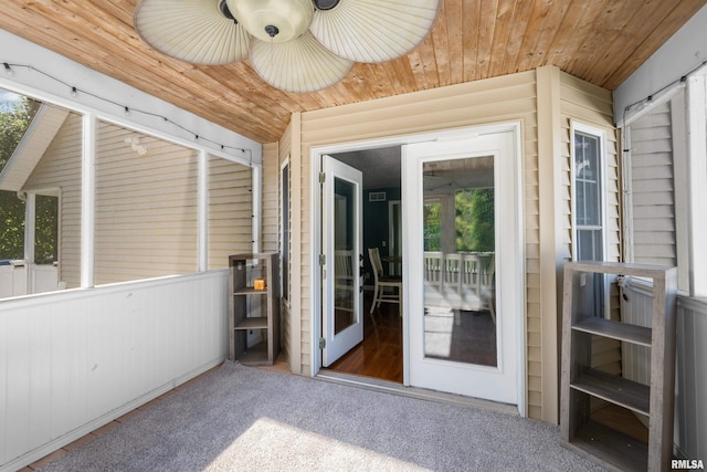 unfurnished sunroom with lofted ceiling, wooden ceiling, and a wealth of natural light