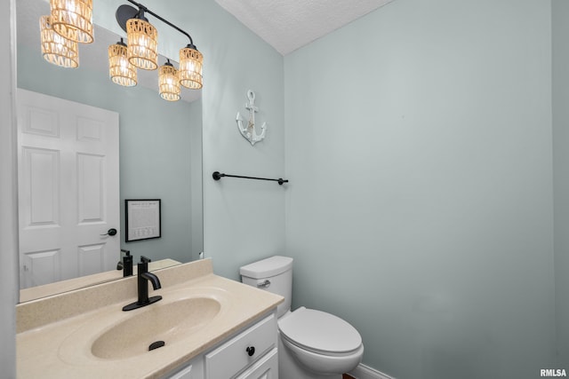 half bath with toilet, a textured ceiling, an inviting chandelier, baseboards, and vanity