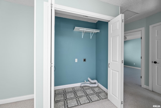 washroom featuring a textured ceiling, carpet floors, baseboards, hookup for an electric dryer, and laundry area