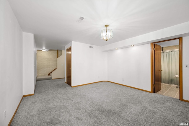 finished below grade area with visible vents, stairway, carpet floors, an inviting chandelier, and baseboards