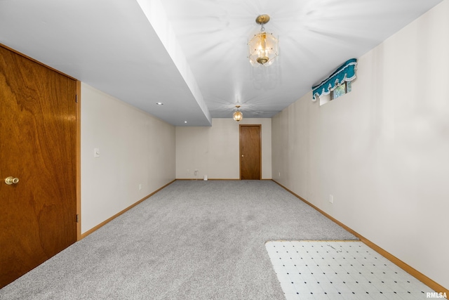 carpeted empty room with baseboards