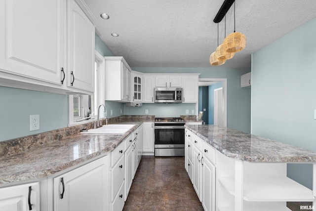 kitchen with a sink, open shelves, a kitchen island, white cabinetry, and stainless steel appliances