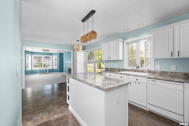 kitchen featuring a center island, open floor plan, white dishwasher, white cabinetry, and a sink