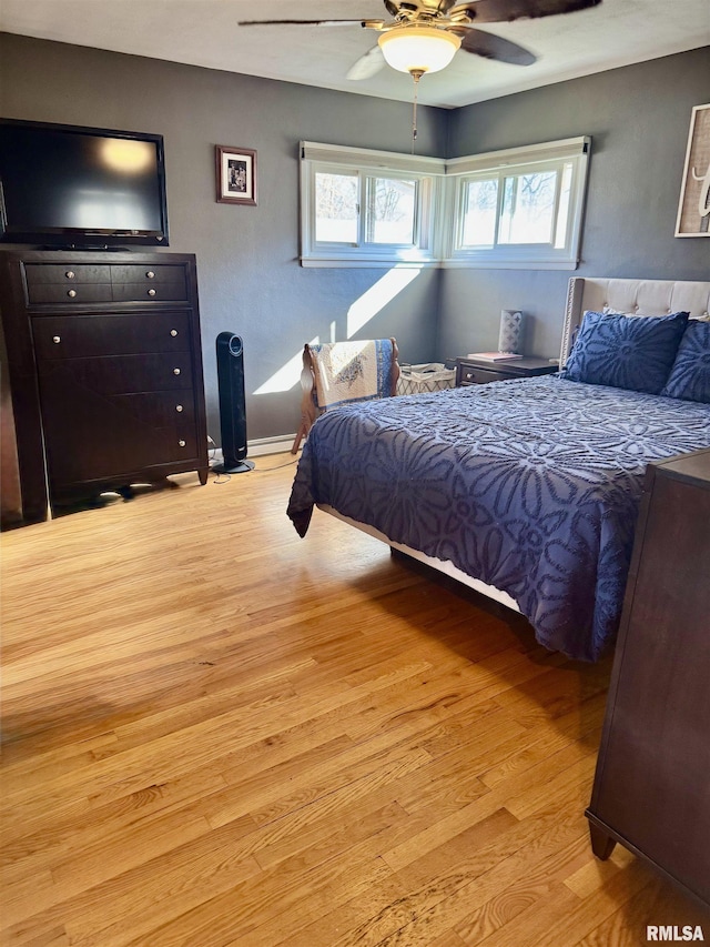 bedroom with light wood-type flooring and a ceiling fan