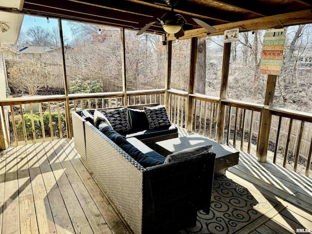 wooden deck with an outdoor hangout area and a ceiling fan