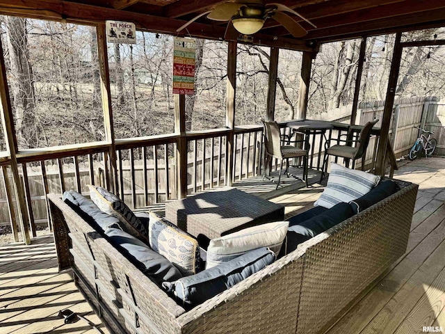 wooden deck with an outdoor living space, a ceiling fan, and fence