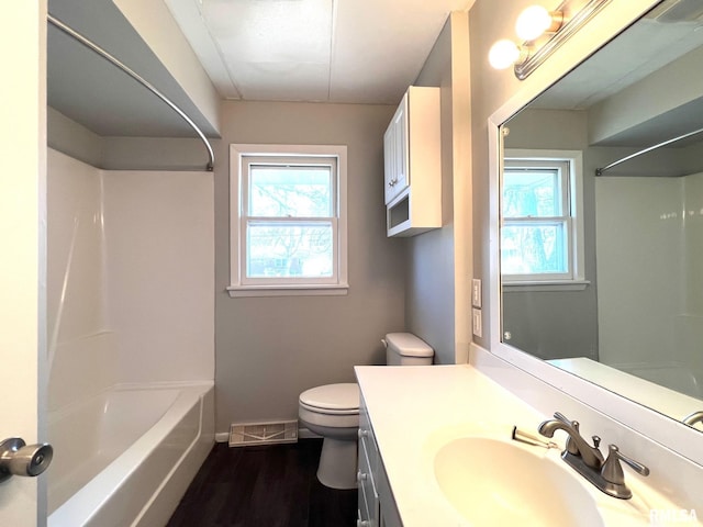 full bathroom with visible vents, a healthy amount of sunlight, toilet, and vanity