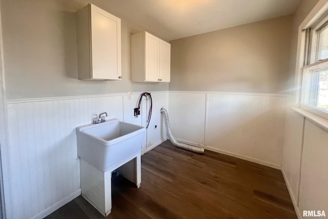 laundry area with cabinet space, dark wood-type flooring, washer hookup, and wainscoting