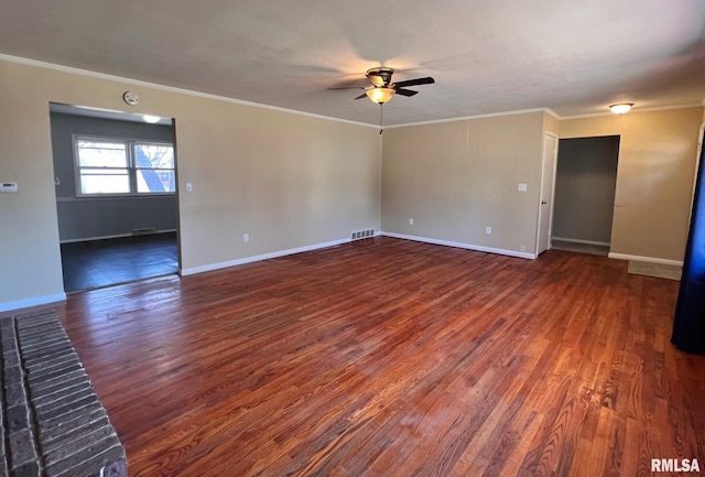 empty room featuring visible vents, crown molding, and wood finished floors