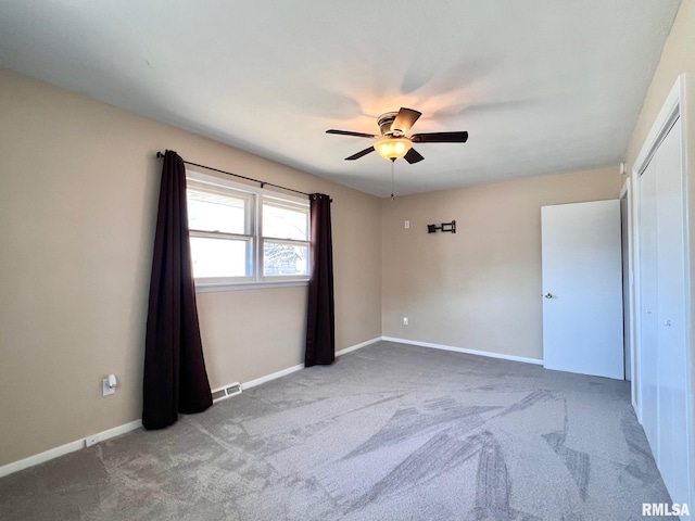 empty room with visible vents, carpet flooring, and baseboards