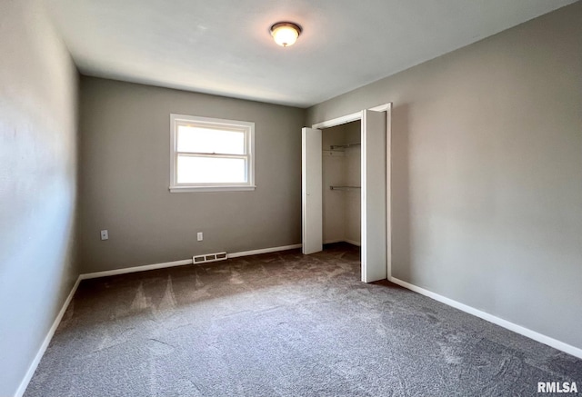 unfurnished bedroom featuring a closet, baseboards, visible vents, and carpet floors