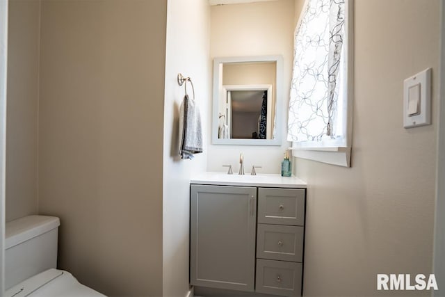 half bathroom featuring toilet and vanity