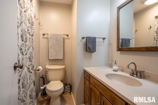 bathroom featuring toilet and vanity