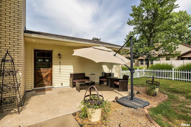 view of patio / terrace featuring an outdoor living space and fence