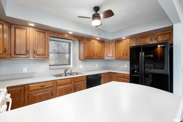 kitchen with brown cabinets, black appliances, a sink, recessed lighting, and light countertops