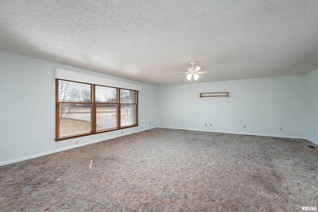 empty room with baseboards, a textured ceiling, and ceiling fan