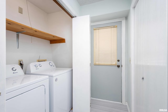 laundry area featuring light wood-style floors, laundry area, baseboards, and independent washer and dryer