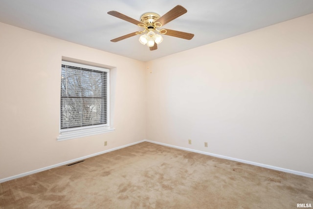 unfurnished room featuring carpet flooring, ceiling fan, baseboards, and visible vents