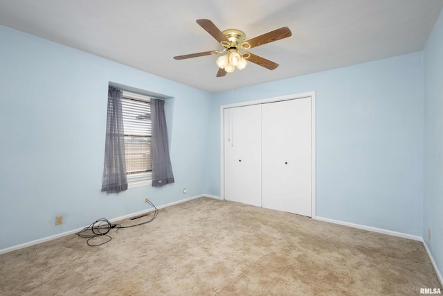 unfurnished bedroom with a ceiling fan, baseboards, a closet, and carpet floors